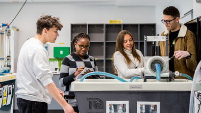 Four students working on an engineering project.