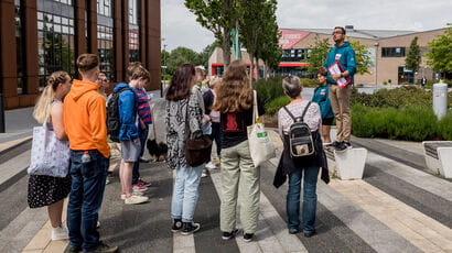 A group of prospective students and their parents and supporters listening to UWE Bristol representative speak.