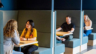 Students chatting in seating booths