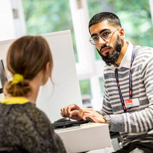 Student Optometrist talking to a patient during a consultation.
