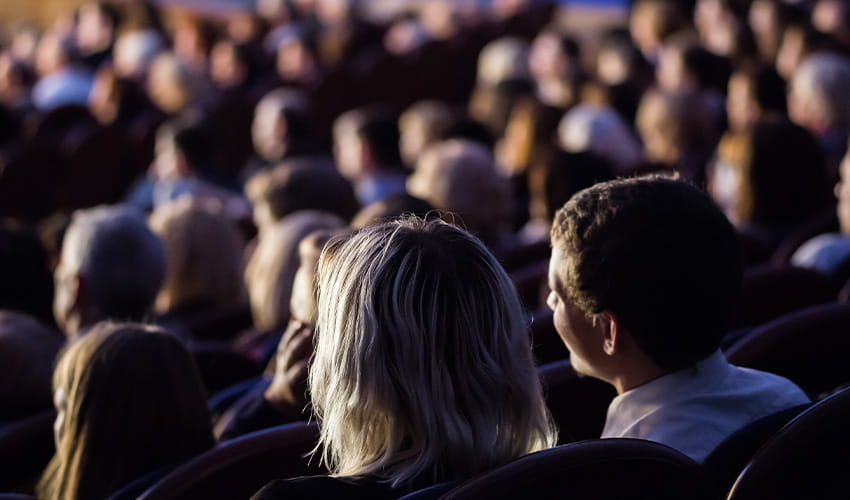 An audience watches a film in a cinema.