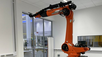 Image of a large red robotic arm in The Bridge Studio.